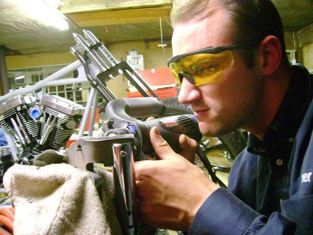 Enlarging mounting holes for proper alignment for kickstand.