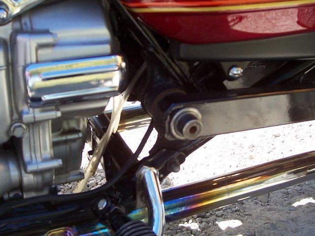 Custom built swing arm is on outside of frame.