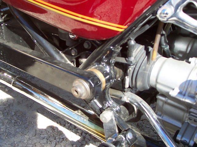 Custom built swing arm is on outside of frame.