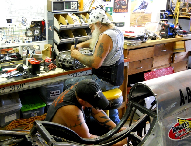 TWO VERY HELPFUL GUYS- HONDA JOE ON THE ENGINE HEADS - FRED WITH THE SHOP AND BIKE