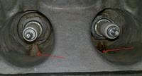 Spark plug drain holes