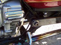Custom built swing arm is on outside of frame.