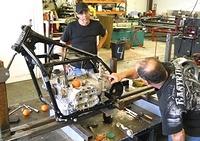 DANNY ON RIGHT OWNER OF ADVANCE WELDING IN DAYTONA POINTING OUT FLAW IN MOTOR MOUNT DESIGN TO ERVING